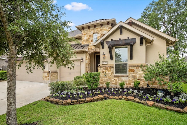 31218 Redwood Manor Ct, Spring, TX 77386 - view of front of home featuring stone siding, a standing seam roof, concrete driveway, and a front yard