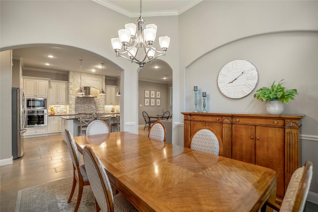 31218 Redwood Manor Ct, Spring, TX 77386 - dining area featuring arched walkways, ornamental molding, a chandelier, recessed lighting, and a towering ceiling