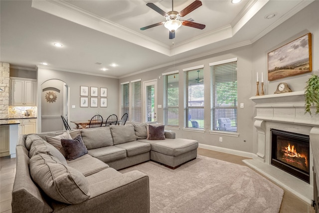 31218 Redwood Manor Ct, Spring, TX 77386 - living room with ceiling fan, a glass covered fireplace, recessed lighting, crown molding, and arched walkways