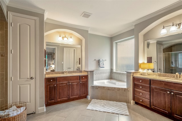 31218 Redwood Manor Ct, Spring, TX 77386 - bathroom featuring two vanities, a bath, a stall shower, tile patterned flooring, and crown molding