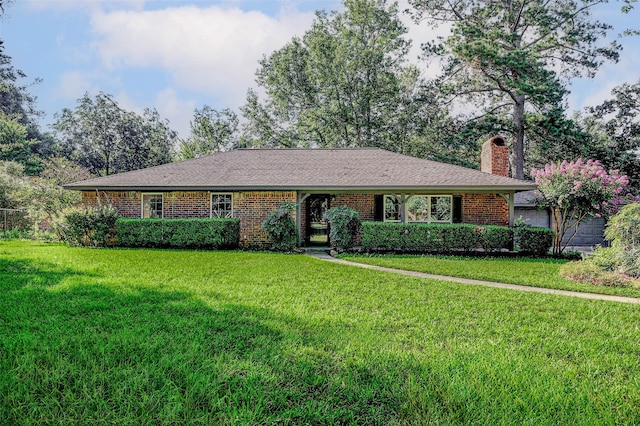907 Kip Ln, Pinehurst, TX 77362 - single story home featuring a front lawn, a chimney, and brick siding
