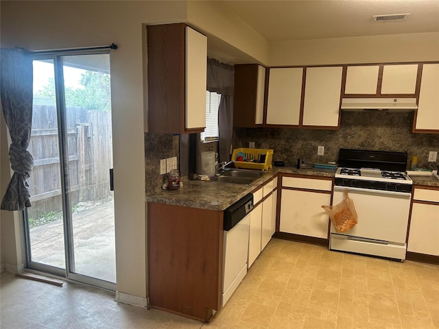 15806 Pin Oak Ridge St, Houston, TX 77073 - kitchen featuring white appliances, decorative backsplash, healthy amount of natural light, and under cabinet range hood