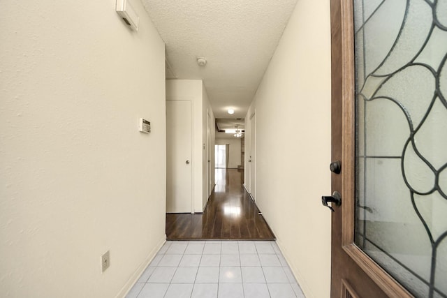 6643 Briar Glade Dr, Houston, TX 77072 - hallway featuring light tile patterned floors and a textured ceiling