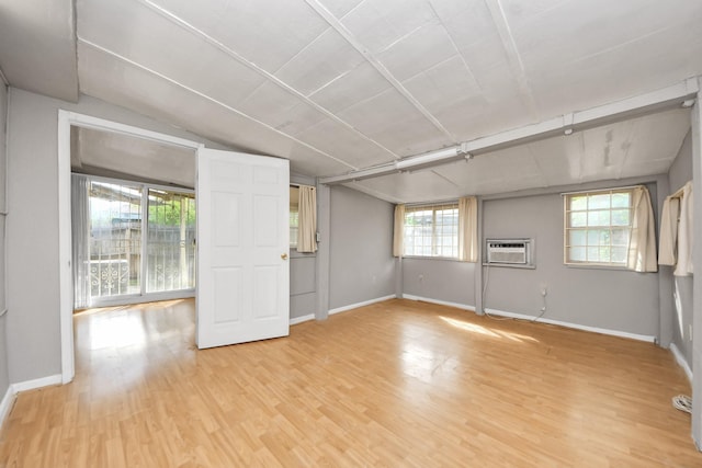 6643 Briar Glade Dr, Houston, TX 77072 - unfurnished room featuring light wood-style flooring, an AC wall unit, and lofted ceiling