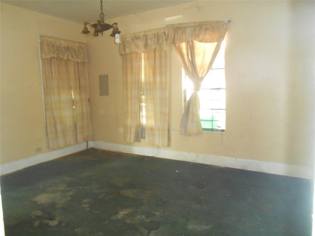 2214 Lee St, Houston, TX 77026 - empty room with concrete flooring and a chandelier