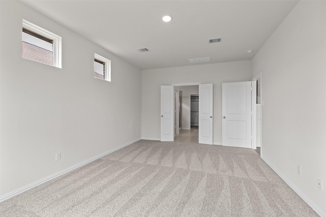 4625 Peony Green Dr, Katy, TX 77493 - unfurnished bedroom featuring light colored carpet, a walk in closet, and recessed lighting