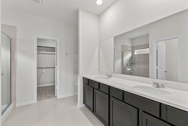 4625 Peony Green Dr, Katy, TX 77493 - full bath with a spacious closet, a shower stall, double vanity, and tile patterned flooring