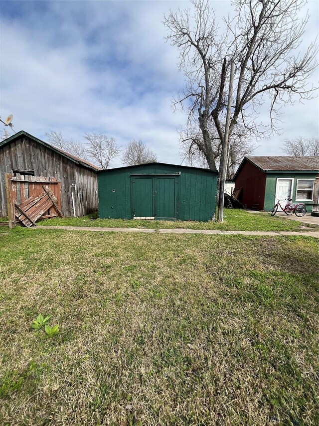 16305 De Zavalla Rd, Channelview, TX 77530 - view of green lawn with an outbuilding