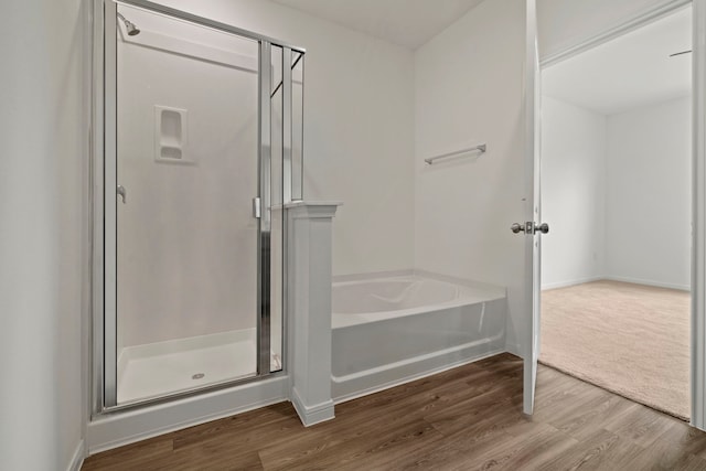 21127 Dolphin Bay Ln, Cypress, TX 77433 - full bathroom featuring a shower stall, wood finished floors, and a garden tub
