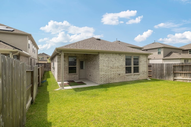 21127 Dolphin Bay Ln, Cypress, TX 77433 - back of house featuring brick siding, a fenced backyard, a shingled roof, and a patio area