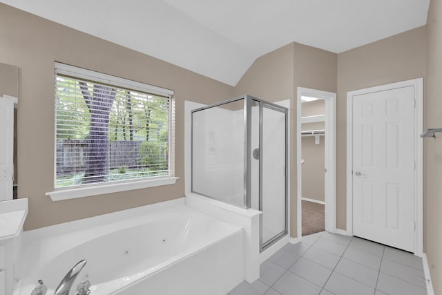 107 W Russet Grove Cir, The Woodlands, TX 77384 - bathroom featuring a stall shower, tile patterned flooring, a tub with jets, lofted ceiling, and a walk in closet
