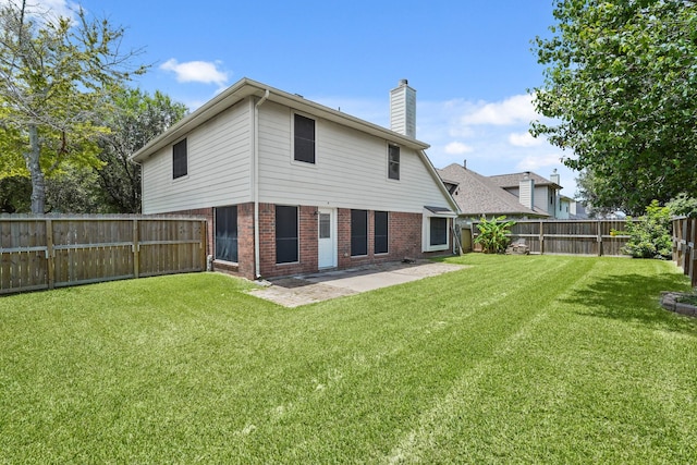 5003 Blanco Dr, Pearland, TX 77584 - rear view of house with a chimney, brick siding, a fenced backyard, and a patio area