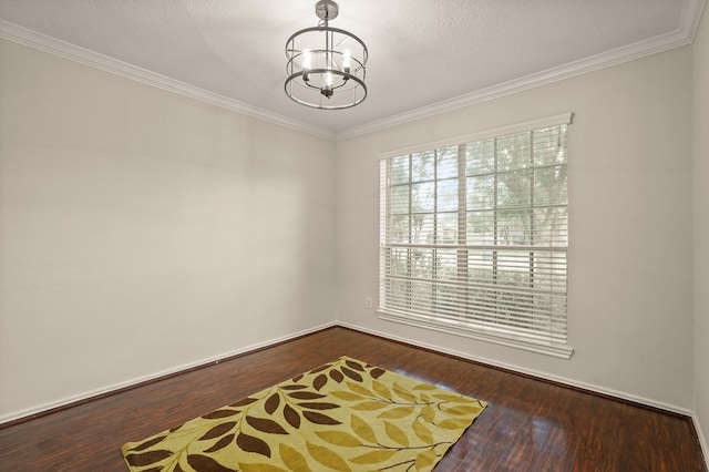 5003 Blanco Dr, Pearland, TX 77584 - empty room featuring a chandelier, dark wood finished floors, and ornamental molding