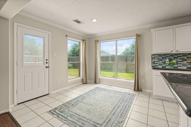 5003 Blanco Dr, Pearland, TX 77584 - unfurnished dining area featuring light tile patterned flooring and crown molding