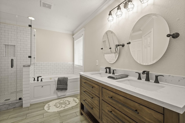 5003 Blanco Dr, Pearland, TX 77584 - full bathroom with a bath, a stall shower, double vanity, crown molding, and wood finished floors