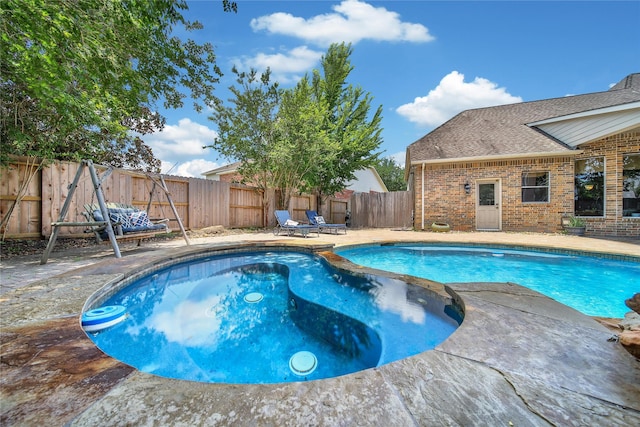 23815 Enchanted Xing, Katy, TX 77494 - view of swimming pool with a fenced backyard, a patio area, and a pool with connected hot tub