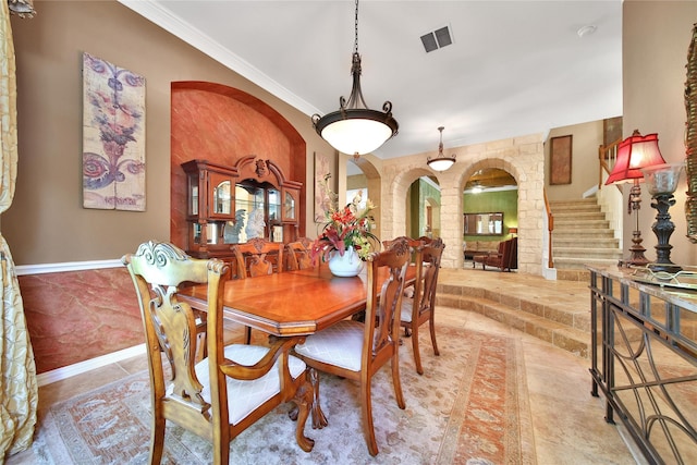 23815 Enchanted Xing, Katy, TX 77494 - dining room with arched walkways, stairs, ornamental molding, and decorative columns