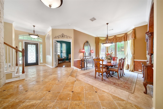 23815 Enchanted Xing, Katy, TX 77494 - dining space with arched walkways, plenty of natural light, ornamental molding, stairway, and wainscoting