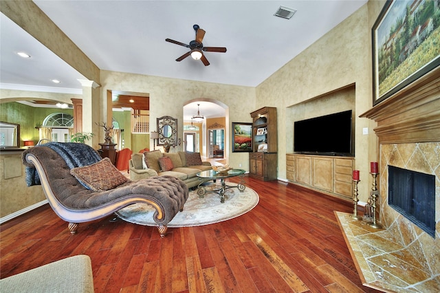 23815 Enchanted Xing, Katy, TX 77494 - living room featuring arched walkways, ceiling fan, wood-type flooring, and a high end fireplace