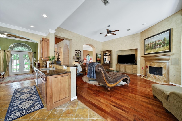 23815 Enchanted Xing, Katy, TX 77494 - living room featuring a ceiling fan, arched walkways, a premium fireplace, crown molding, and recessed lighting
