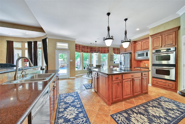 23815 Enchanted Xing, Katy, TX 77494 - kitchen with appliances with stainless steel finishes, crown molding, hanging light fixtures, a kitchen island, and recessed lighting