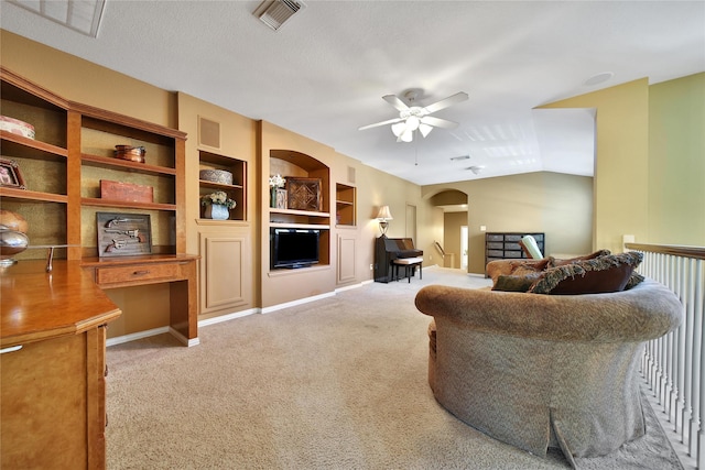 23815 Enchanted Xing, Katy, TX 77494 - carpeted living room featuring a ceiling fan, built in features, and arched walkways