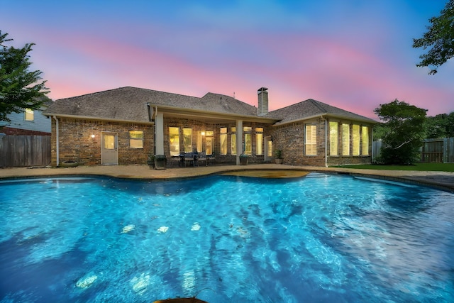 23815 Enchanted Xing, Katy, TX 77494 - pool at dusk featuring a patio area