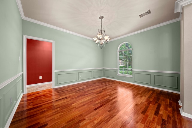 1808 Brookside Dr, Friendswood, TX 77546 - unfurnished room featuring crown molding, wood finished floors, a chandelier, wainscoting, and a decorative wall