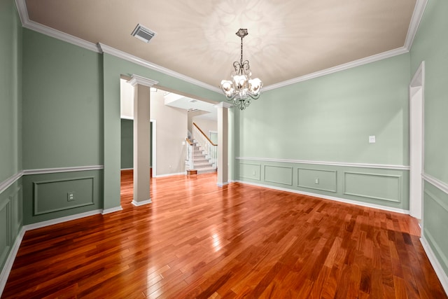 1808 Brookside Dr, Friendswood, TX 77546 - spare room featuring a chandelier, stairs, crown molding, wood finished floors, and a decorative wall