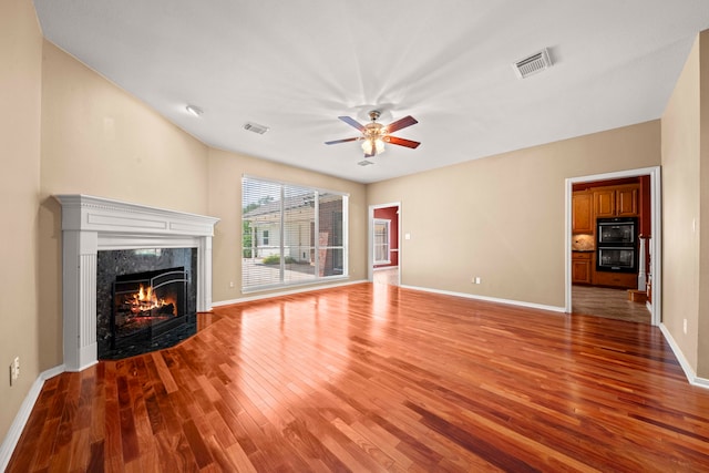 1808 Brookside Dr, Friendswood, TX 77546 - unfurnished living room featuring light wood finished floors, ceiling fan, and a fireplace