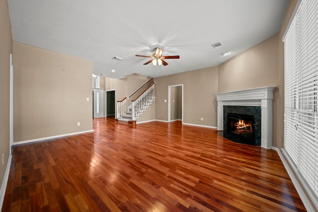 1808 Brookside Dr, Friendswood, TX 77546 - unfurnished living room featuring wood finished floors, a fireplace, a ceiling fan, stairway, and plenty of natural light