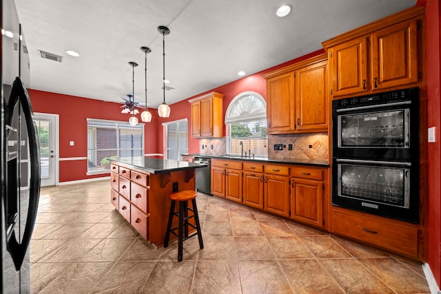 1808 Brookside Dr, Friendswood, TX 77546 - kitchen featuring black appliances, a ceiling fan, dark countertops, decorative backsplash, and a center island
