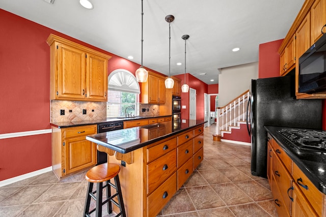 1808 Brookside Dr, Friendswood, TX 77546 - kitchen featuring dark countertops, a center island, black appliances, decorative backsplash, and brown cabinetry