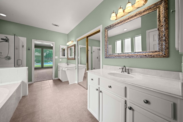 1808 Brookside Dr, Friendswood, TX 77546 - bathroom featuring a stall shower, two vanities, and a garden tub