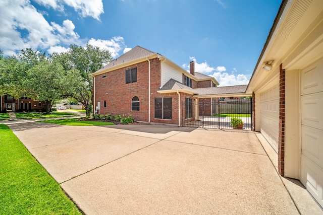1808 Brookside Dr, Friendswood, TX 77546 - back of house with brick siding, concrete driveway, roof with shingles, a chimney, and a garage