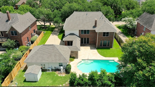 1808 Brookside Dr, Friendswood, TX 77546 - view of swimming pool featuring a storage unit, a fenced backyard, and a patio