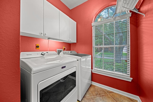 1808 Brookside Dr, Friendswood, TX 77546 - laundry area featuring cabinet space, washer and dryer, a textured wall, and light tile patterned flooring