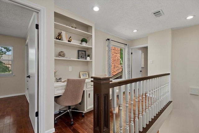 15502 Rana Ct, Houston, TX 77068 - office area with dark wood-style flooring, a textured ceiling, built in desk, and recessed lighting