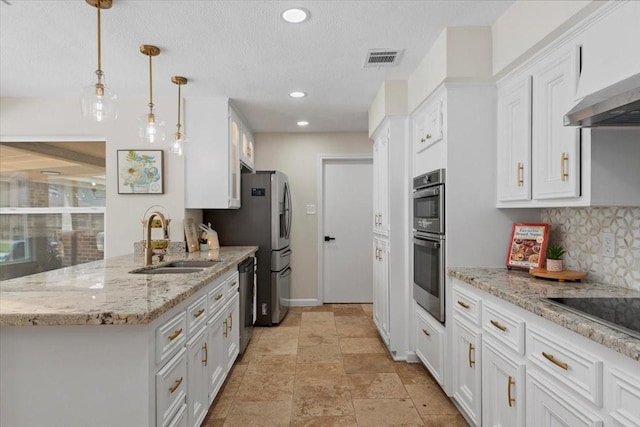 15502 Rana Ct, Houston, TX 77068 - kitchen with stainless steel appliances, white cabinets, tasteful backsplash, a peninsula, and light stone countertops