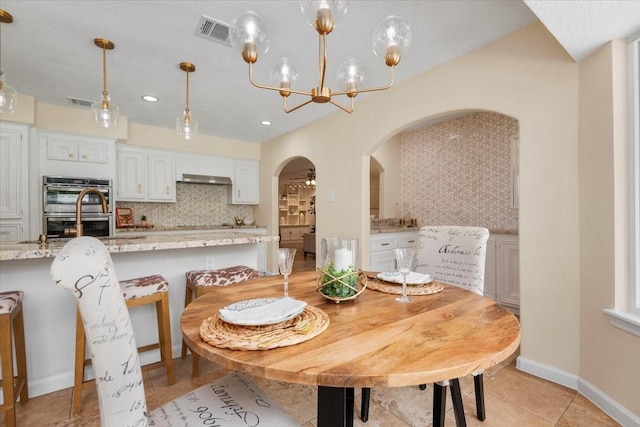 15502 Rana Ct, Houston, TX 77068 - dining area featuring arched walkways, a chandelier, recessed lighting, and light tile patterned floors