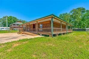 2884 W Fm 1988, Livingston, TX 77351 - view of property exterior featuring a lawn