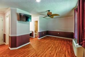2884 W Fm 1988, Livingston, TX 77351 - empty room with crown molding, ceiling fan, and wood finished floors