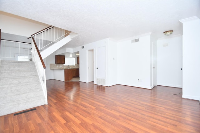 10018 Knoboak Dr Unit 21, Houston, TX 77080 - unfurnished living room with dark wood-type flooring and stairs