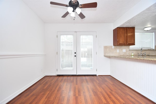 10018 Knoboak Dr Unit 21, Houston, TX 77080 - kitchen featuring dark wood-style flooring, french doors, healthy amount of natural light, and brown cabinets