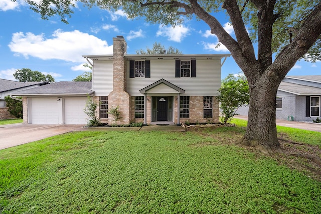 21710 Rotherham Dr, Spring, TX 77388 - view of front of house featuring a chimney, brick siding, a garage, a front lawn, and concrete driveway