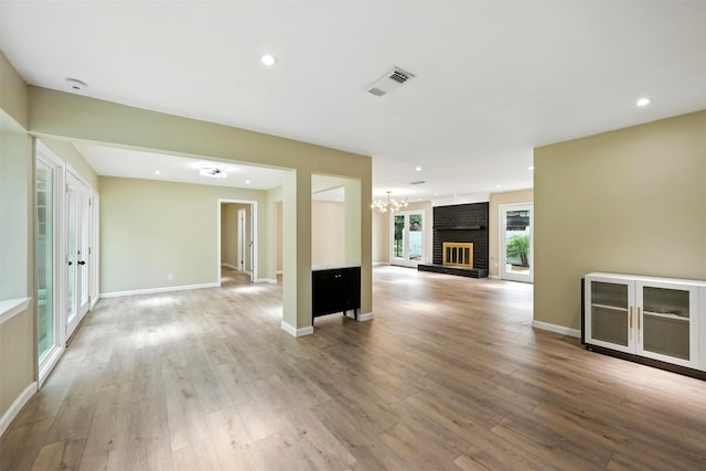 11726 Gardenglen Dr, Houston, TX 77070 - unfurnished living room with a chandelier, light wood-style flooring, and recessed lighting