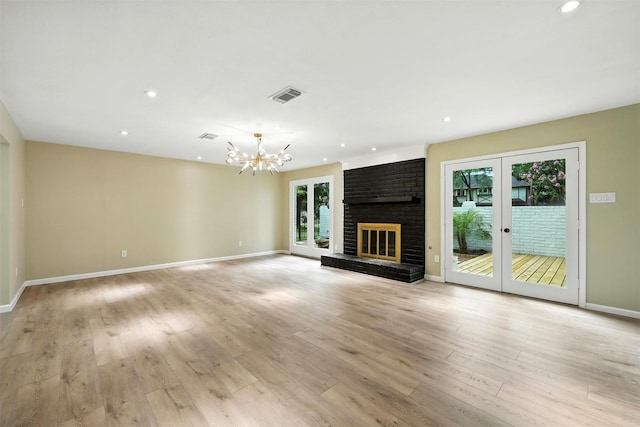 11726 Gardenglen Dr, Houston, TX 77070 - unfurnished living room with a chandelier, a brick fireplace, light wood-type flooring, and recessed lighting