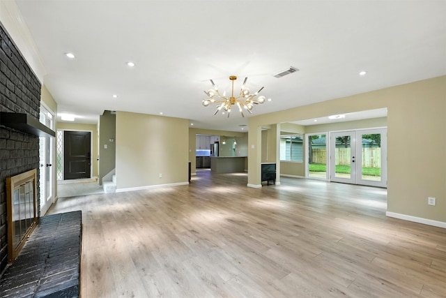 11726 Gardenglen Dr, Houston, TX 77070 - unfurnished living room featuring a fireplace, a chandelier, light wood-style floors, stairway, and recessed lighting