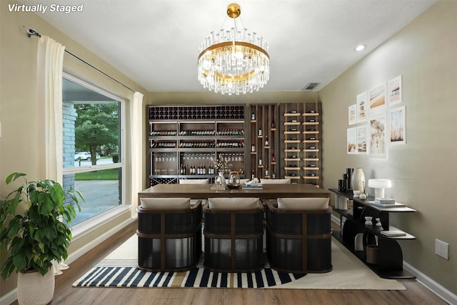 11726 Gardenglen Dr, Houston, TX 77070 - wine cellar with wood finished floors and a chandelier
