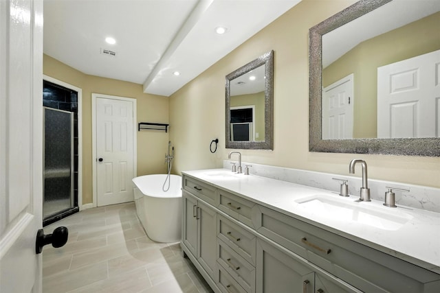 11726 Gardenglen Dr, Houston, TX 77070 - full bathroom with double vanity, a stall shower, a soaking tub, and recessed lighting